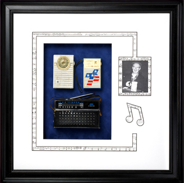 Custom framed shadowbox design with vintage radios, a picture of radio operator and musical notes cut into the matting.