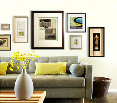 Couch with multiple pieces of custom framed artwork hung above