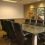 Conference room with conference table, chairs and beautifully framed custom artwork.