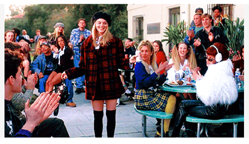 Girl in plaid jacket getting applause from classmates