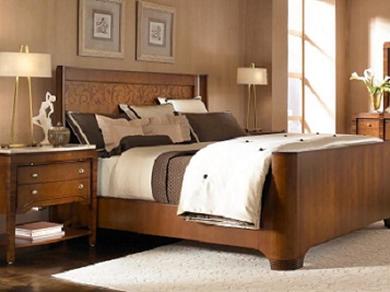 Bedroom photograph with furniture and custom framed art hanging above the bed.