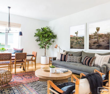 Living area with furniture and two custom framed pictures of desert landscape