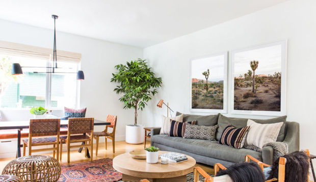 Living area with furniture and two custom framed pictures of desert landscape