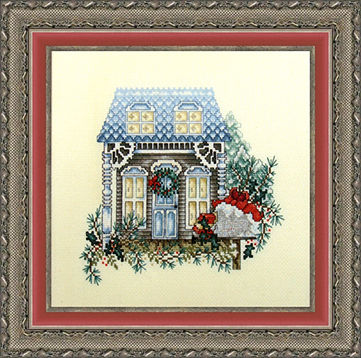 Framed piece showing a cross stitched piece of art depicting a home and landscaping.