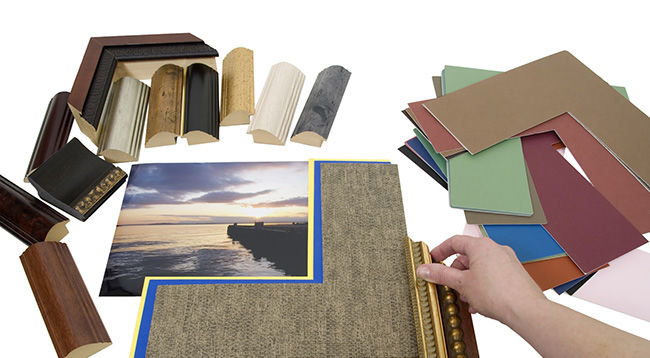 Deciding on a framing project with an assortment of colored matboard and frame samples