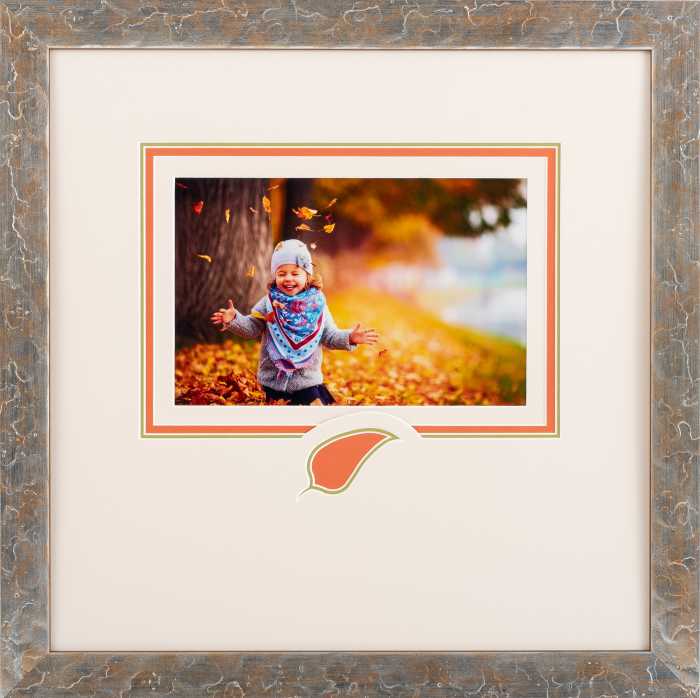 Framed girl playing in leaves